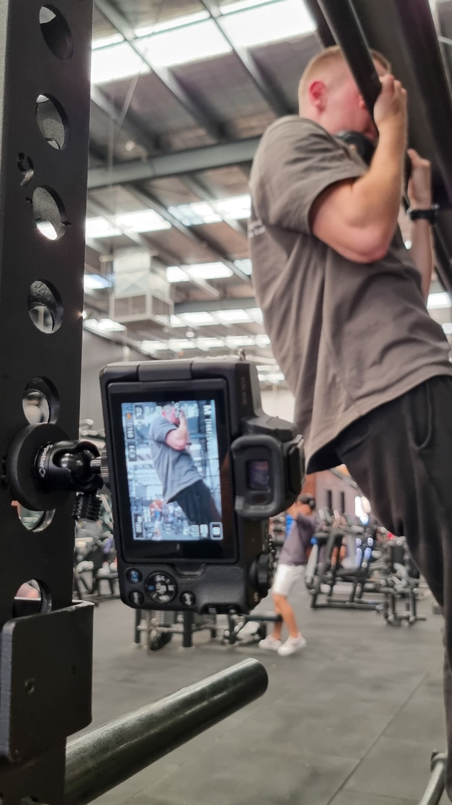 A phone mounted to gym equipment with Spotter